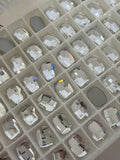 Clear Swarovski graphic flat-back oval crystals in organizer compartments