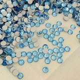 Preciosa MAXIMA Rose, no hotfix, flat back crystals scattered, colour Aquamarine, dura foil backing shown up close