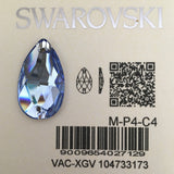 A teardrop-shaped Swarovski crystal with a faceted Light Sapphire colour, shown on its beige backing card with the Swarovski logo, a QR code, and barcode details.
