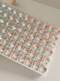 Close up group of Swarovski crystal article 3200 Rivol 2 hole sew on stones.  Crystal Shimmer is a subtle iridescent effect