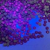 Swarovski article 2088 XIRIUS Rose scattered crystals, Electric Violet colour under black light torch to show glowing ability