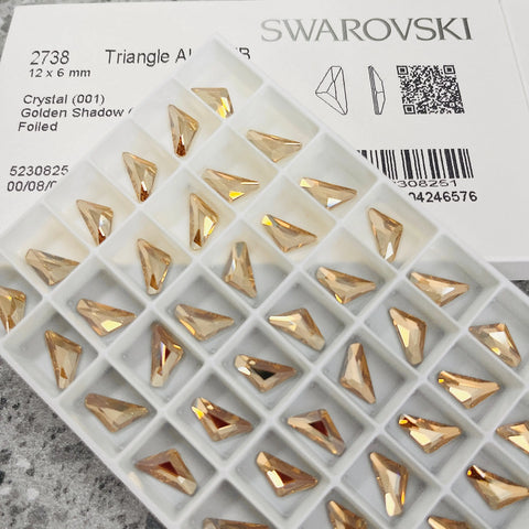 Golden shadow triangle crystal beads in white divided tray, Swarovski 2738 shown