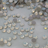 A close-up of many small round rhinestones by preciosa the colour is called White Opal the Dura foiling is shown.