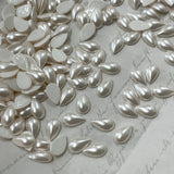 Pear-shaped pearl white hotfix crystal drops on backing sheet, mixed sizes