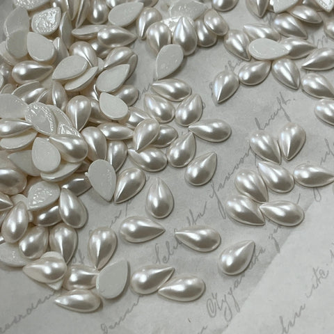 Pear-shaped pearl white hotfix crystal drops on backing sheet, mixed sizes