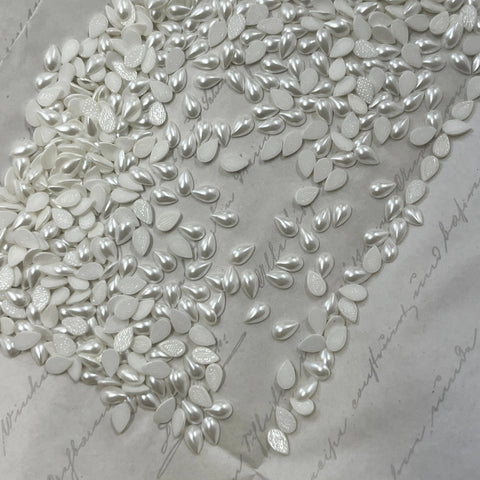 Pearl drop-shaped hotfix crystals, teardrop cabochon gems in a pile