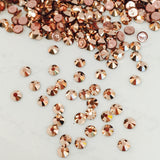 actual photo of iron on diamantes Swarovski with heat activated glue on the back colour is Rose Gold