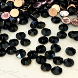 actual photo of Swarovski Crystal Hot Fix diamantes in Jet a solid pitch black with heat sensitive glue on the back