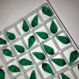 actual photo of a tray of Swarovski Crystal Article 6000 teardrop pendants in dark emerald green colour