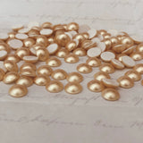 actual photo of stocked hotfix crystal pearls in Vintage Gold colour